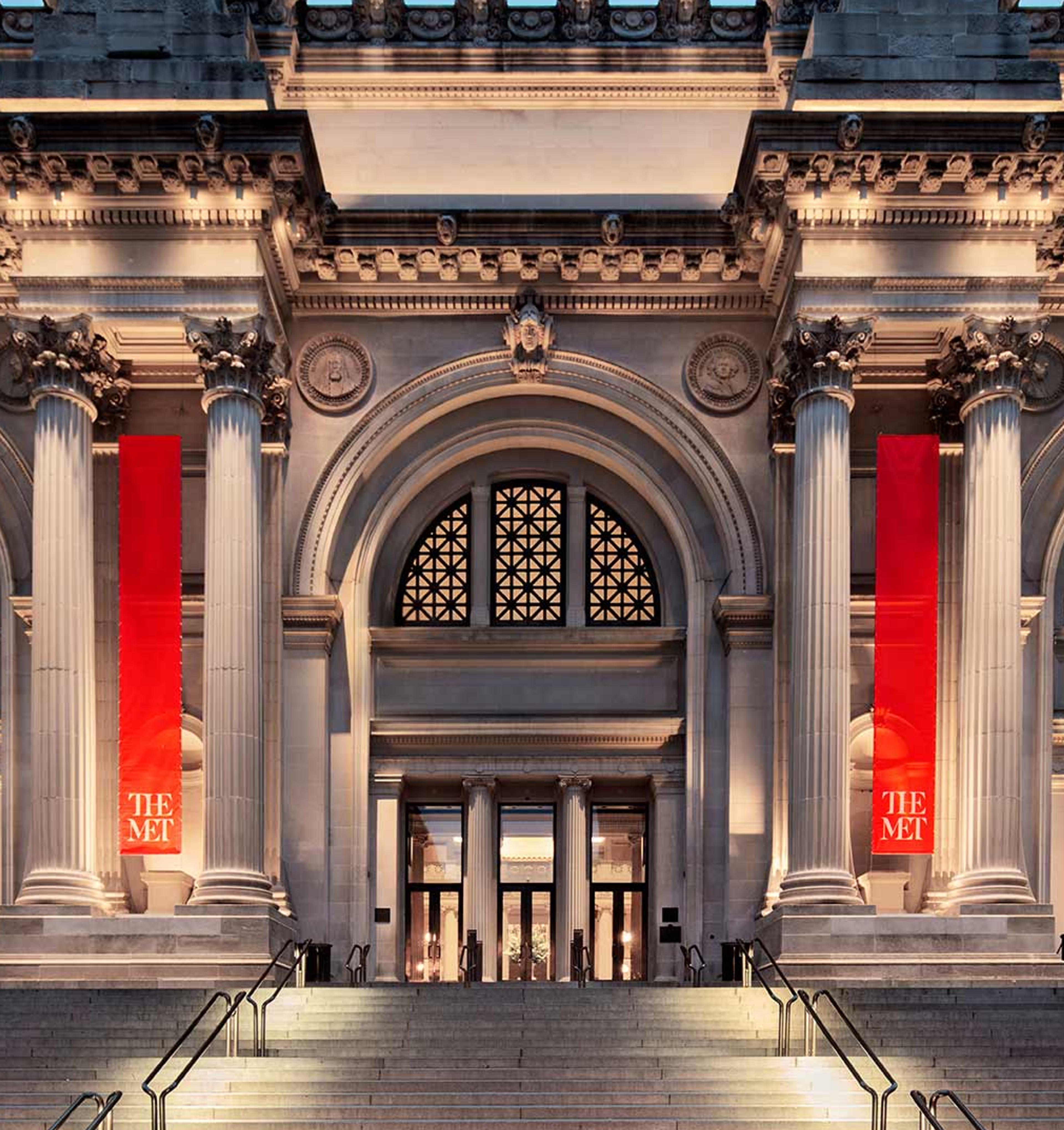 The Met's facade illuminated at dusk.