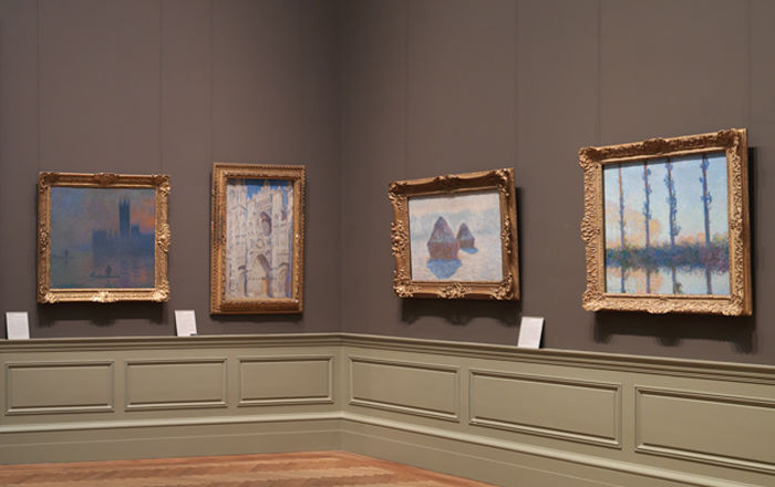 View of a gallery with four Monet paintings